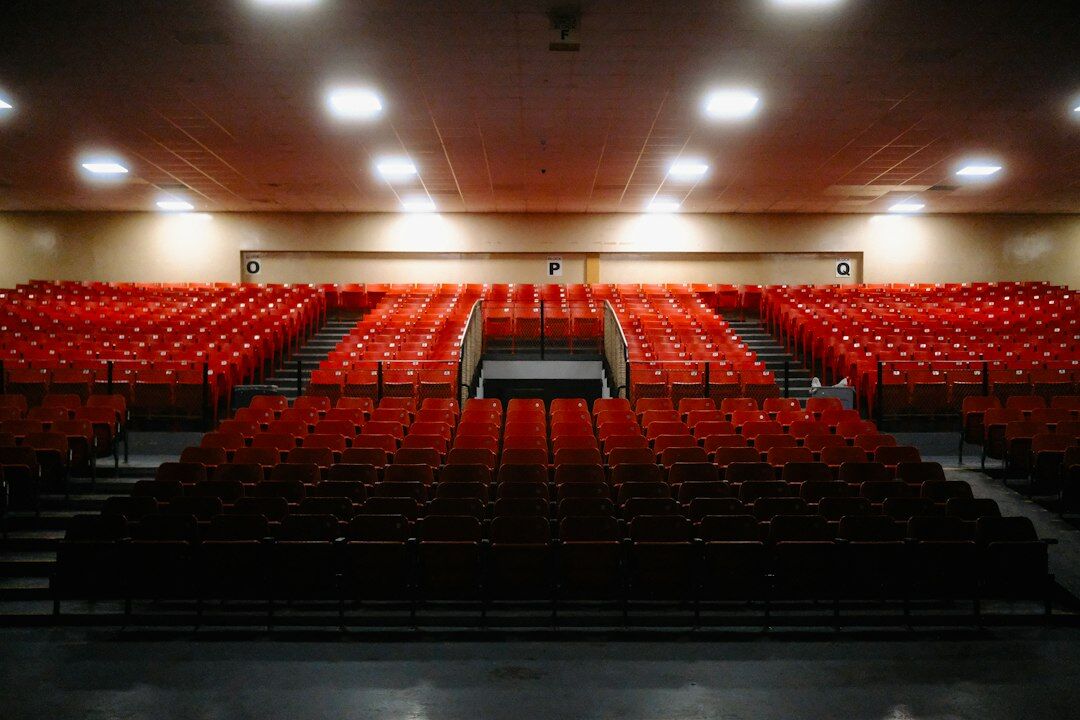 Empty auditorium with a lectern and rows of chairs