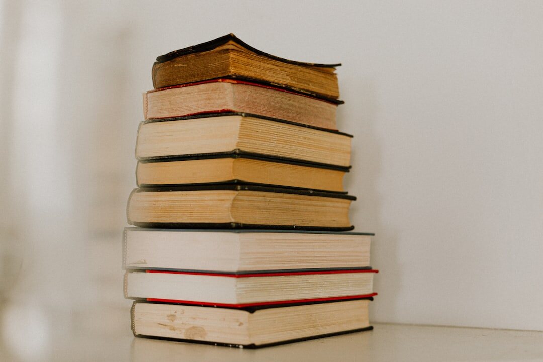 Stack of books and notebooks about communication on a shelf
